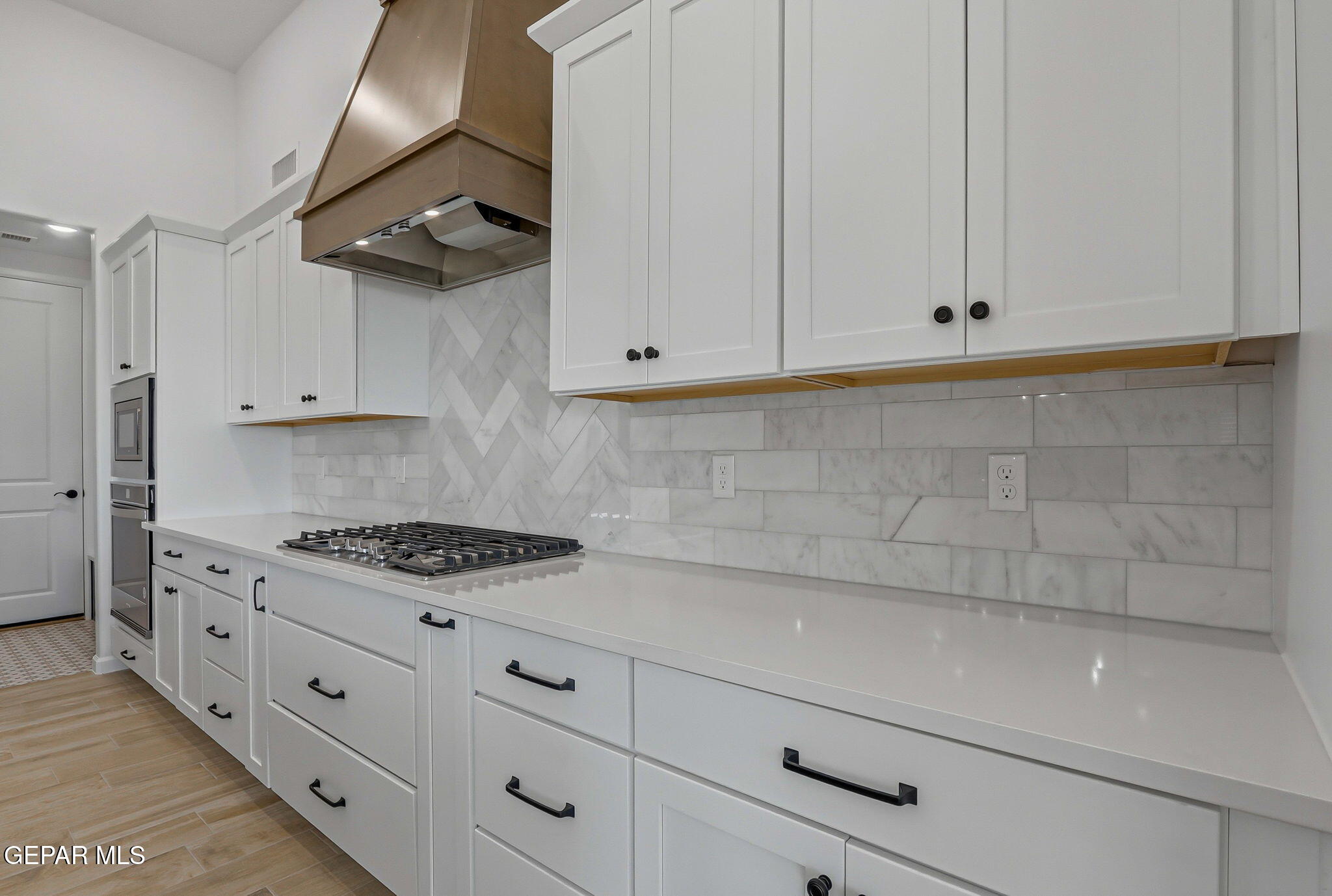 7416 Cimarron Rim Drive El Paso, TX 79911 - Photo 20 of 58 a kitchen with white cabinets and white appliances