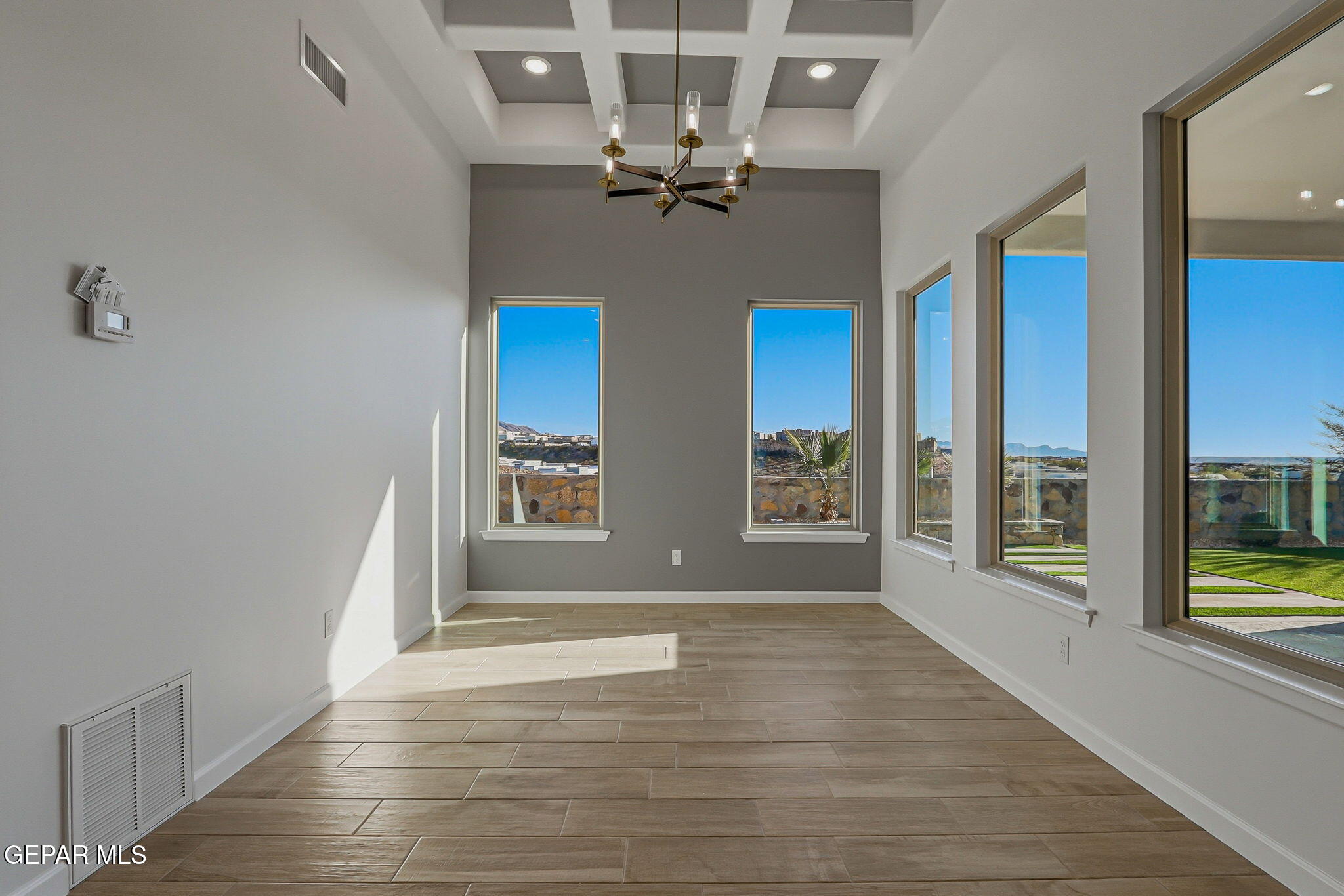 7416 Cimarron Rim Drive El Paso, TX 79911 - Photo 23 of 58 a view of an empty room with a window and wooden floor