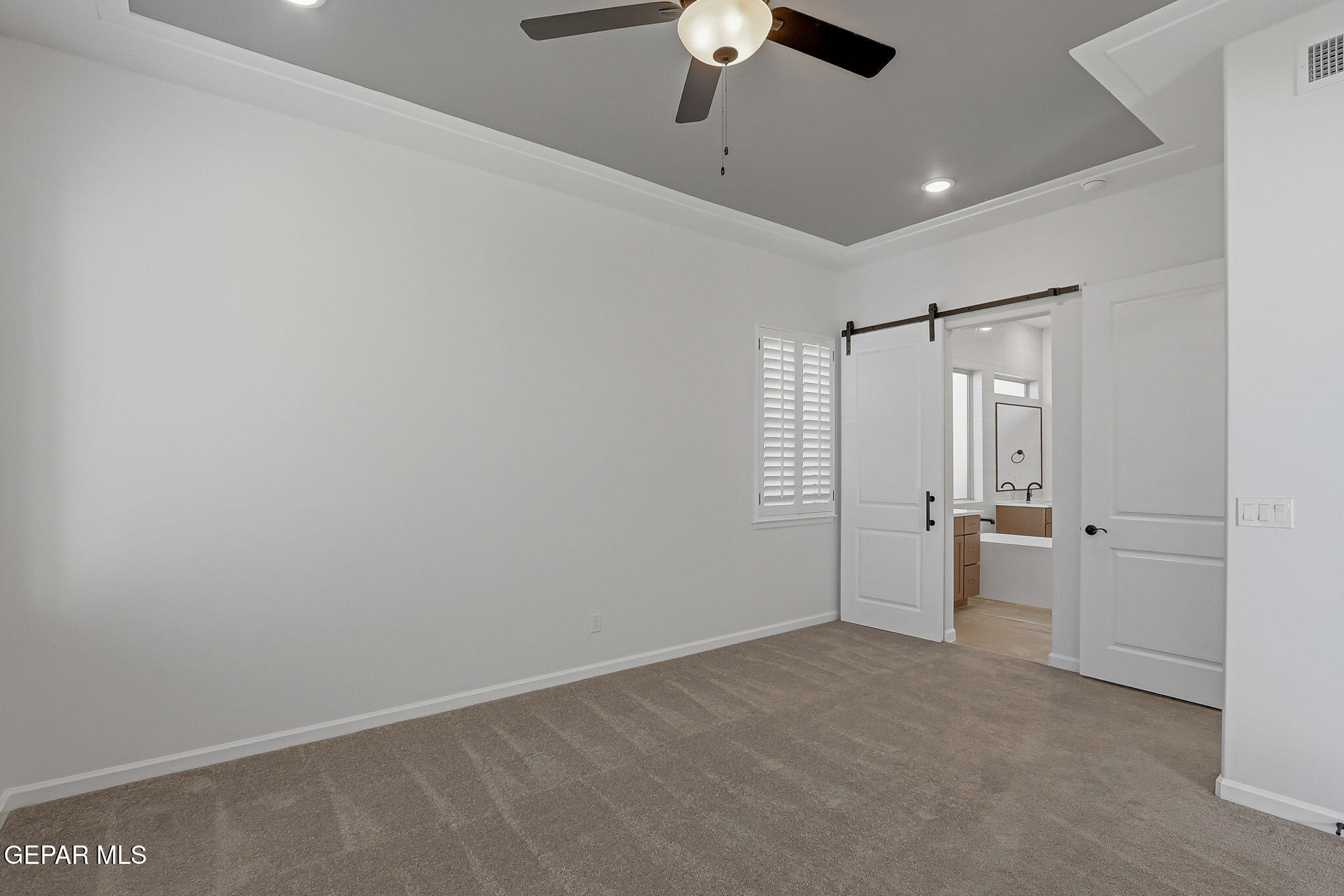 7416 Cimarron Rim Drive El Paso, TX 79911 - Photo 26 of 58 an empty room with chandelier fan and windows