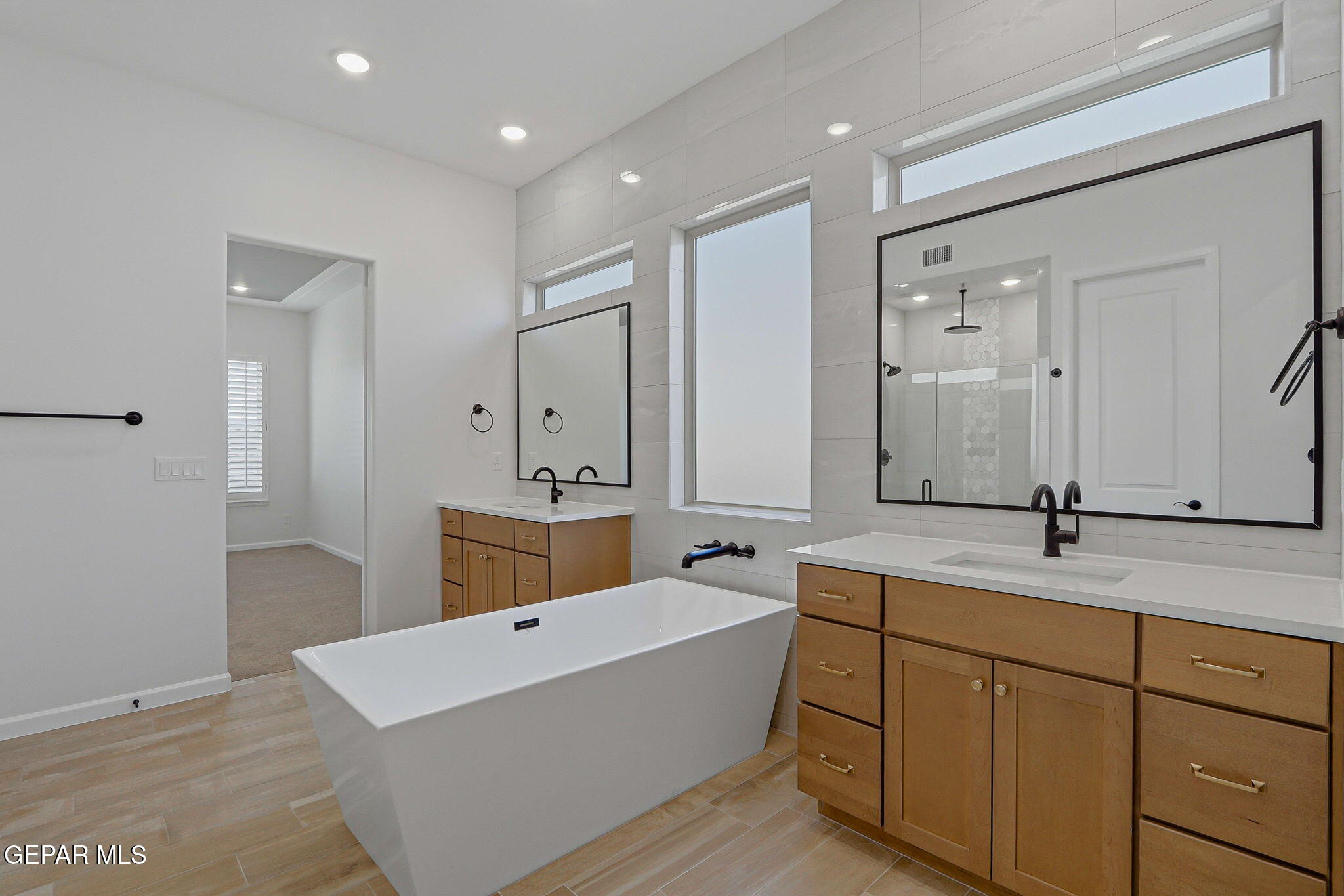 7416 Cimarron Rim Drive El Paso, TX 79911 - Photo 29 of 58 a spacious bathroom with a double vanity sink mirror and double