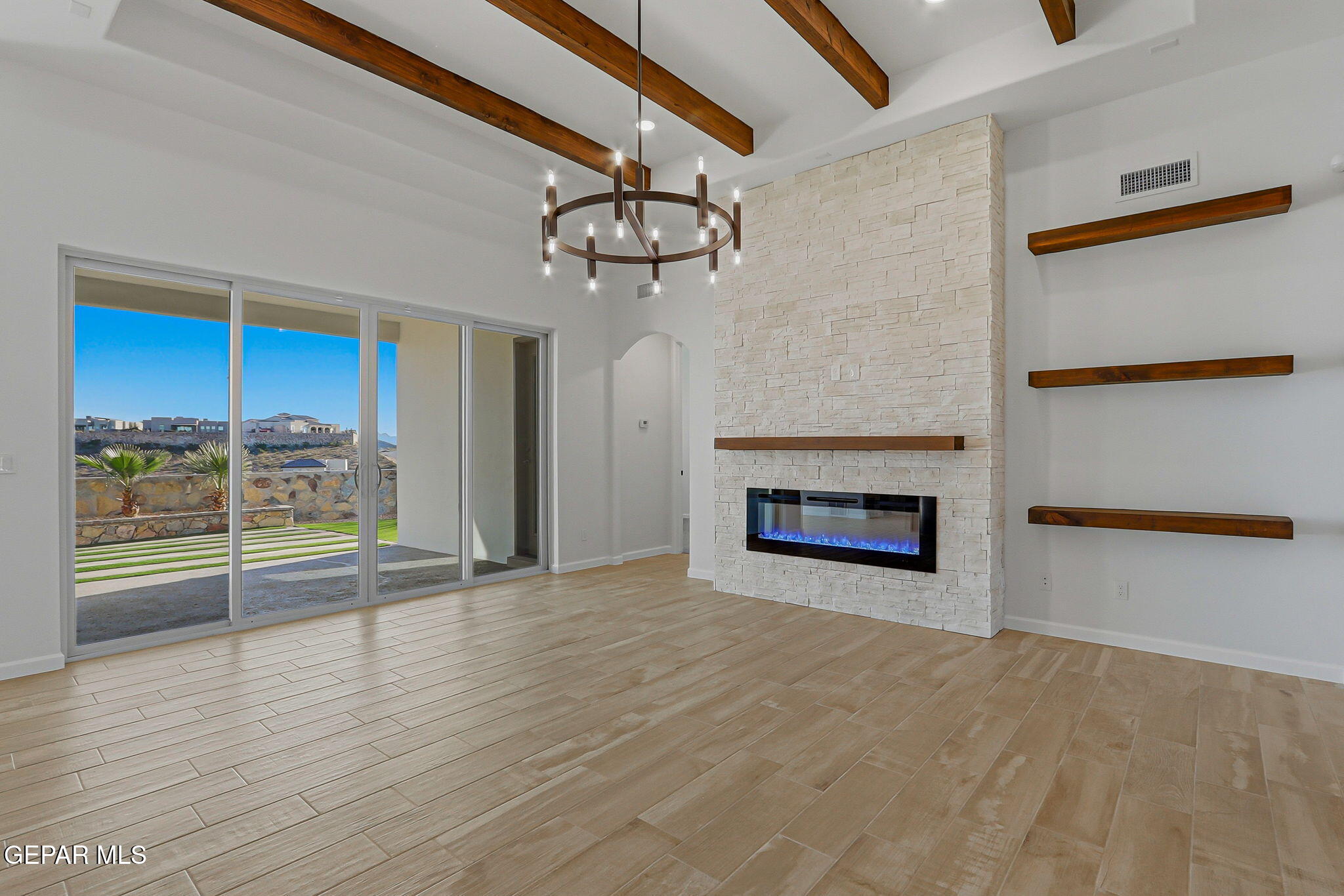 7416 Cimarron Rim Drive El Paso, TX 79911 - Photo 9 of 58 a view of an empty room with a fireplace and a window