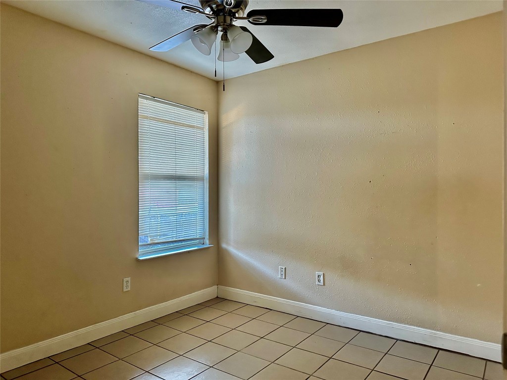 Undisclosed Address Austin, TX 78752 - Photo 11 of 15 an empty room with windows and fan