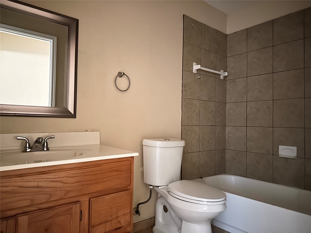 Undisclosed Address Austin, TX 78752 - Photo 12 of 15 a bathroom with a sink a toilet and a mirror