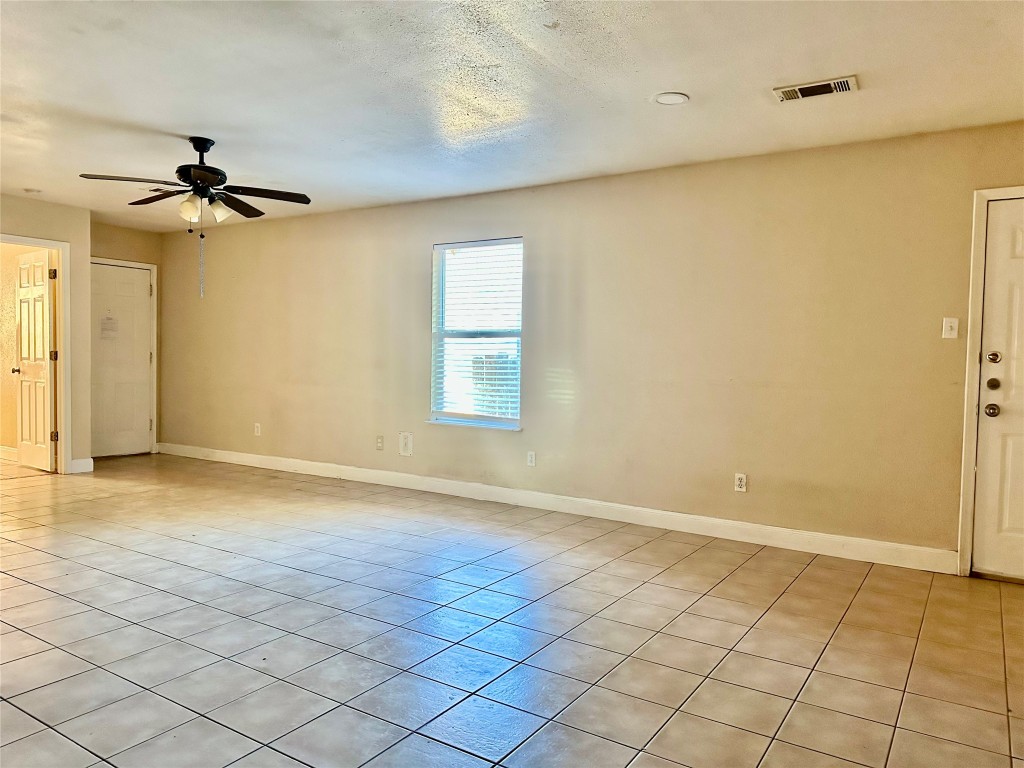 Undisclosed Address Austin, TX 78752 - Photo 6 of 15 an empty room with windows and fan