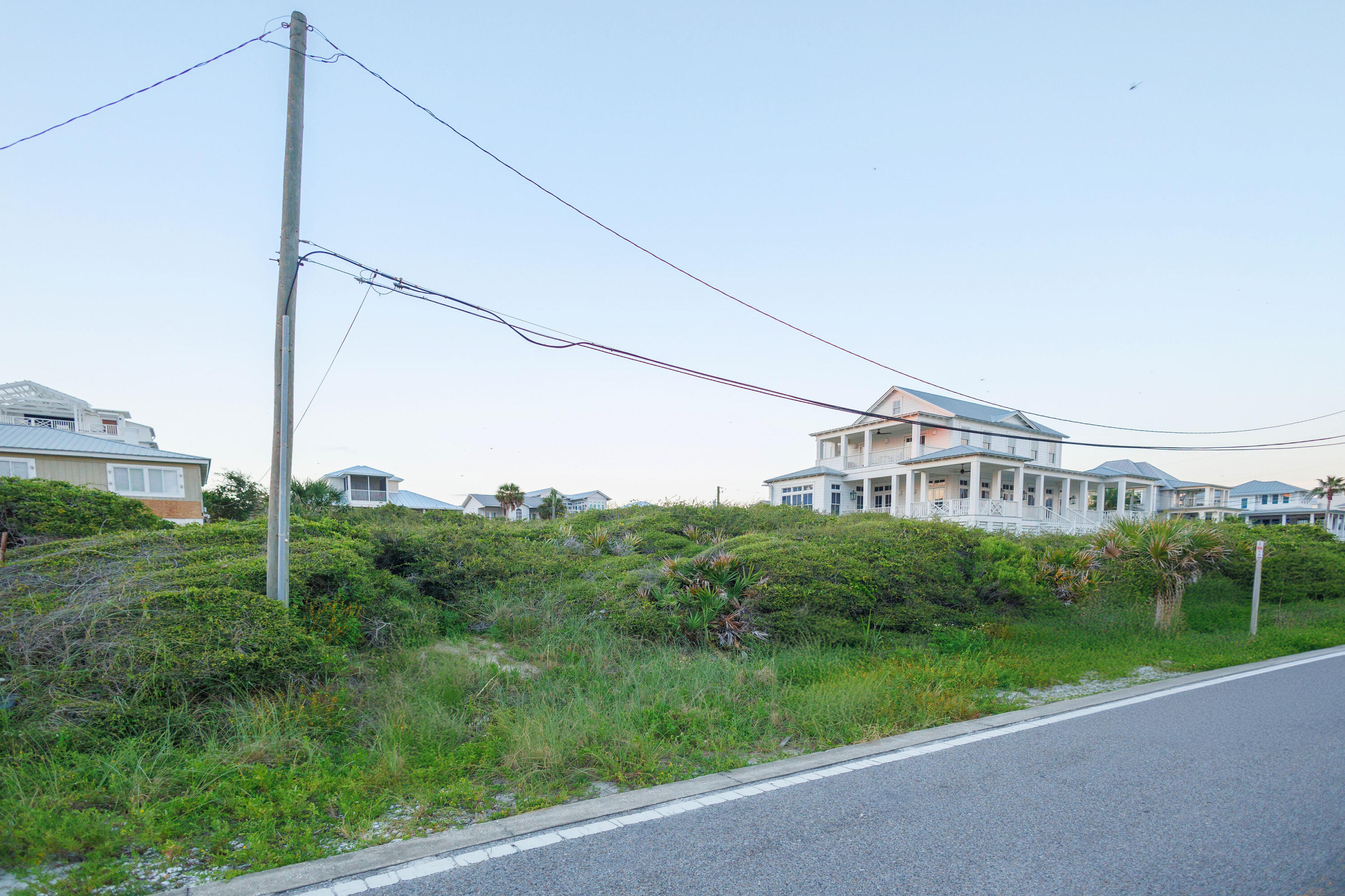 0 Pompano St Inlet Beach Inlet Beach, FL 32461 - Photo 12 of 14 a view of a house next to a big yard and large trees