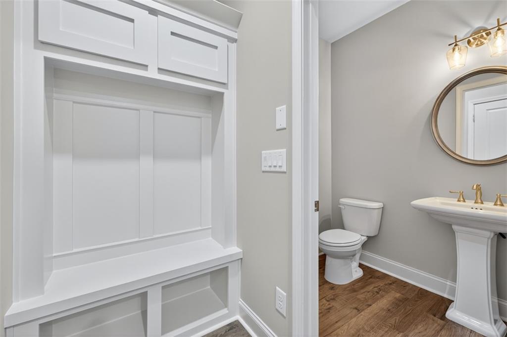 8845 Jot Em Down Road Gainesville, GA 30506 - Photo 30 of 87 a bathroom with a toilet and a sink