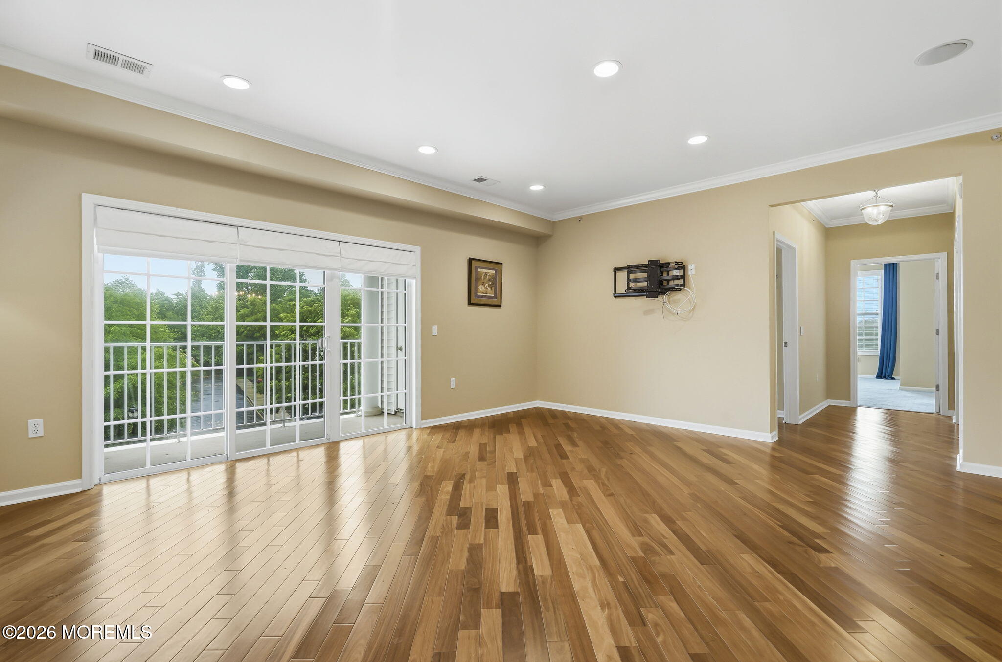 106 Potts Road Morganville, NJ 07751 - Photo 5 of 25 a view of an empty room with wooden floor and a window