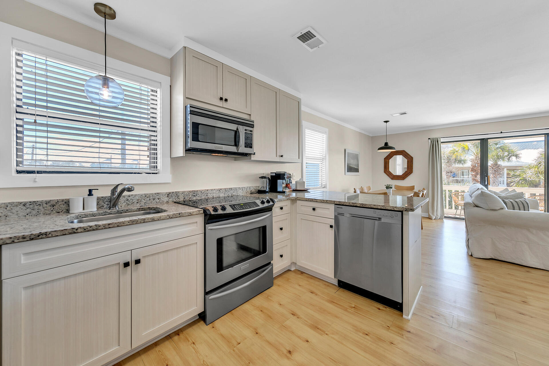 3799 East County Highway 30A, Unit H6 Santa Rosa Beach, FL 32459 - Photo 13 of 40 a kitchen with granite countertop stainless steel appliances a stove sink and microwave