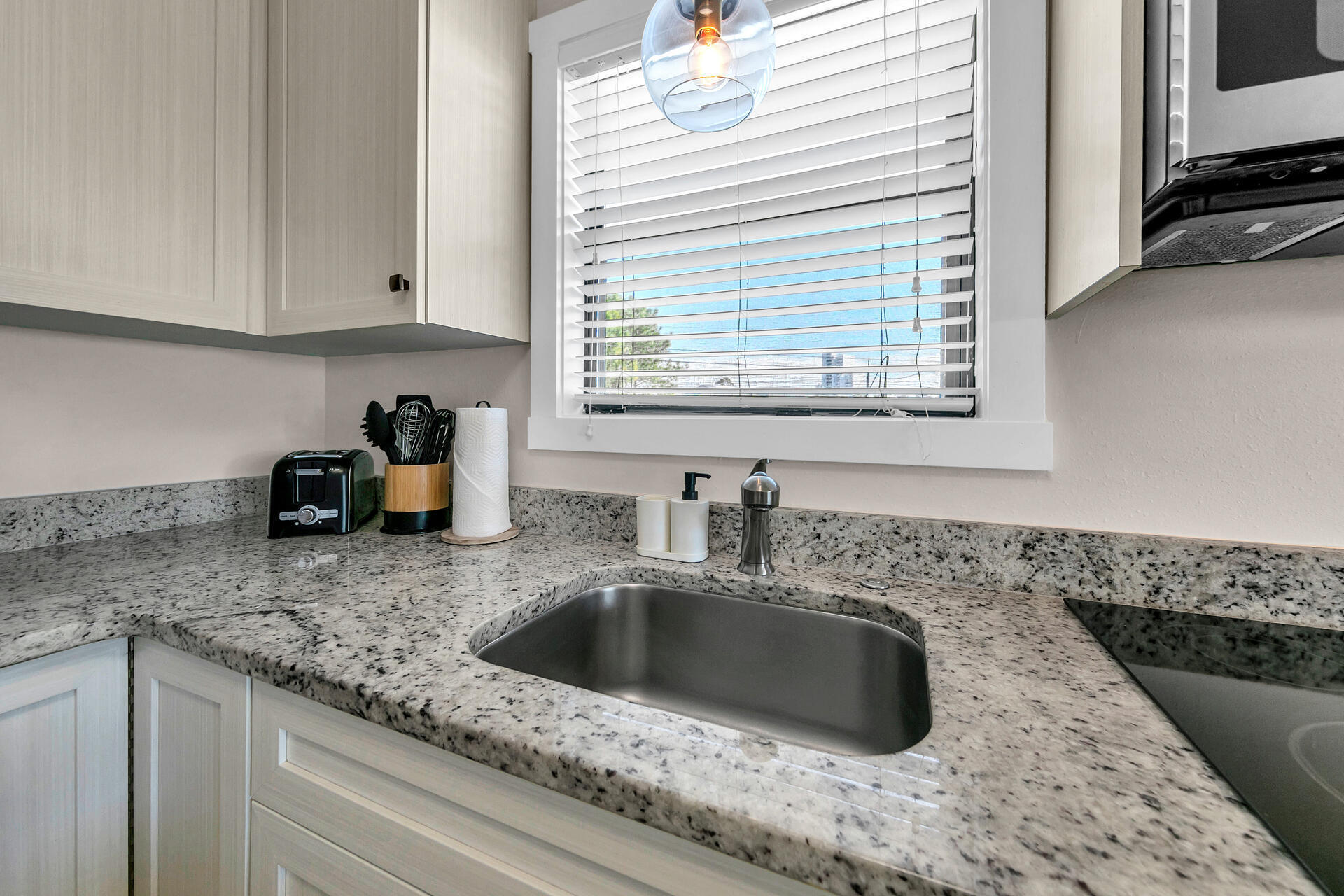3799 East County Highway 30A, Unit H6 Santa Rosa Beach, FL 32459 - Photo 14 of 40 a kitchen with sink a window and cabinets