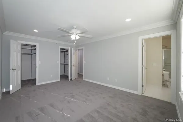 an empty room with fan and entrance