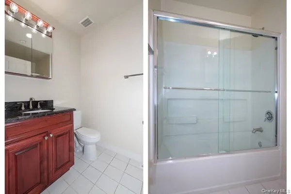 a bathroom with a granite countertop sink toilet and shower