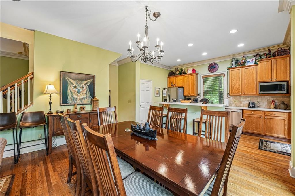 14 Laurel Ridge Lane Big Canoe, GA 30143 - Photo 13 of 72 a view of a dining room with furniture a chandelier and wooden floor