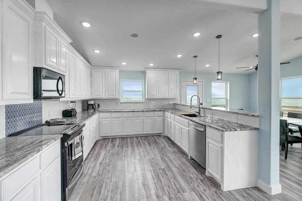 2445 Laguna Shores Road Corpus Christi, TX 78418 - Photo 12 of 39 a kitchen with a white wooden cabinets and white stainless steel appliances