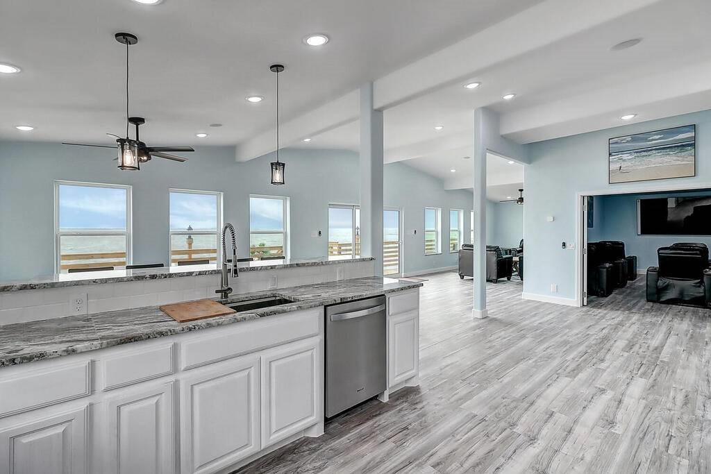 2445 Laguna Shores Road Corpus Christi, TX 78418 - Photo 13 of 39 a large kitchen with granite countertop a large center island a sink stainless steel appliances and cabinets