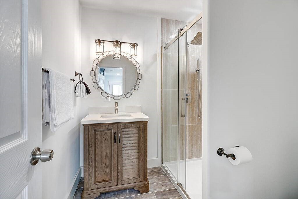 2445 Laguna Shores Road Corpus Christi, TX 78418 - Photo 17 of 39 a bathroom with a sink a mirror and shower