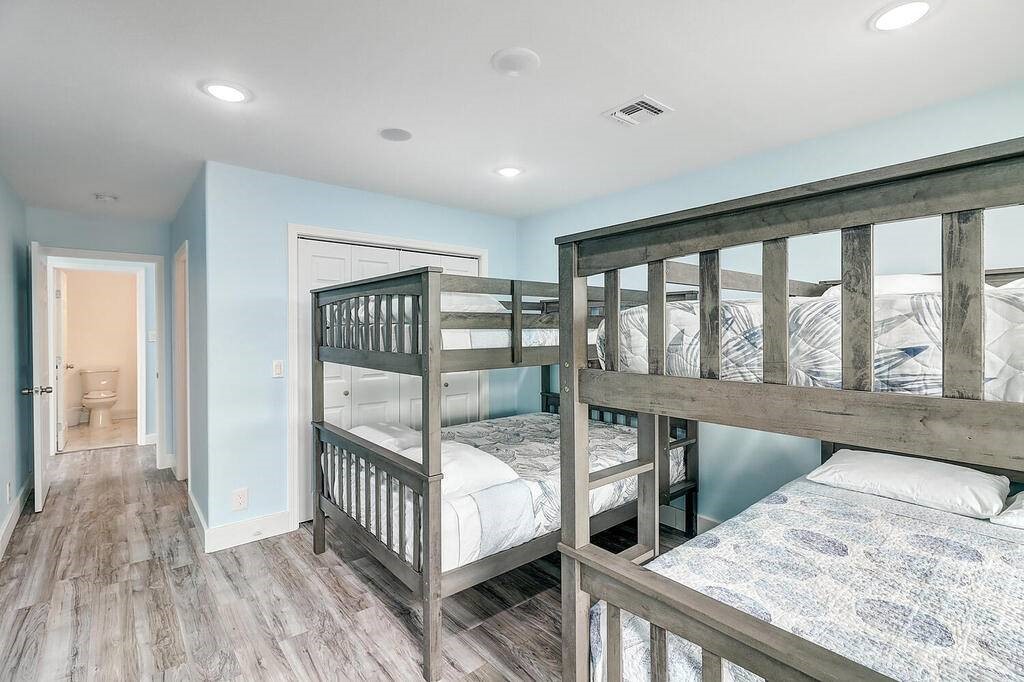 2445 Laguna Shores Road Corpus Christi, TX 78418 - Photo 27 of 39 a bedroom with furniture window and wooden floor