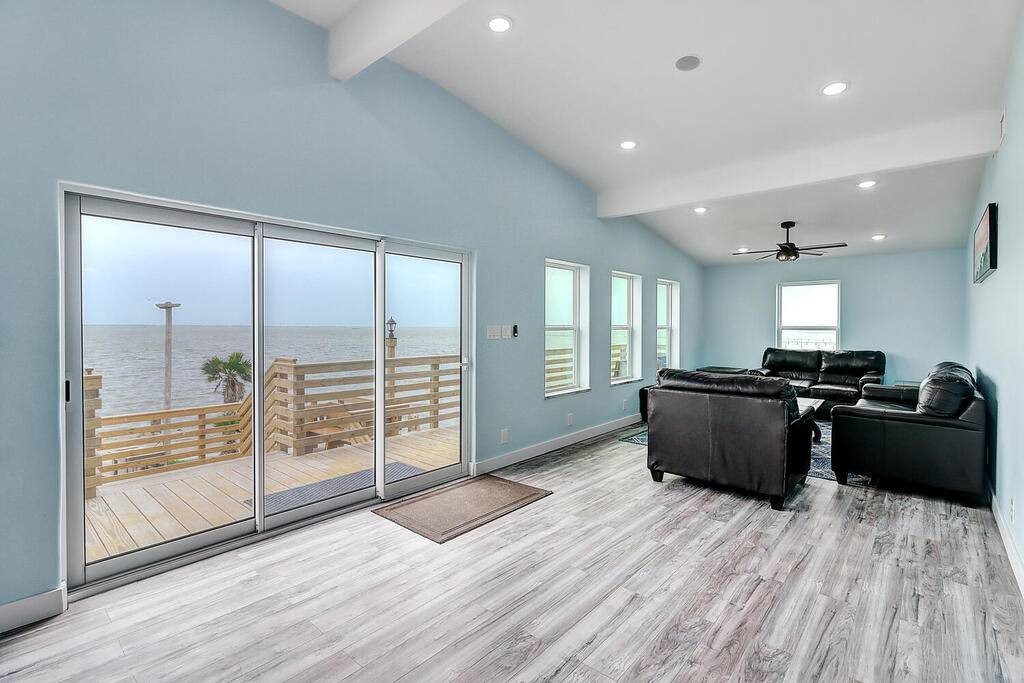 2445 Laguna Shores Road Corpus Christi, TX 78418 - Photo 4 of 39 a view of a big room with wooden floor and windows