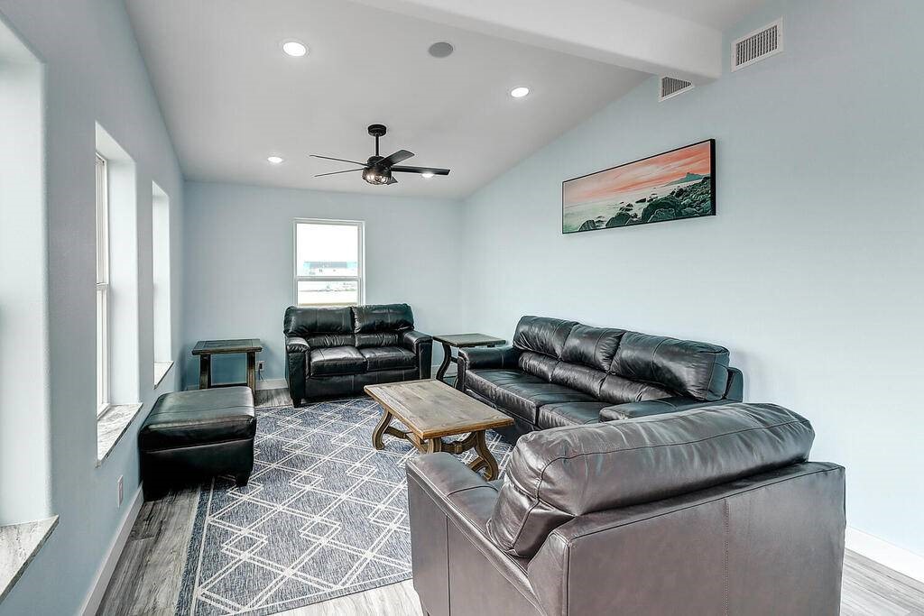 2445 Laguna Shores Road Corpus Christi, TX 78418 - Photo 5 of 39 a living room with furniture and a chandelier