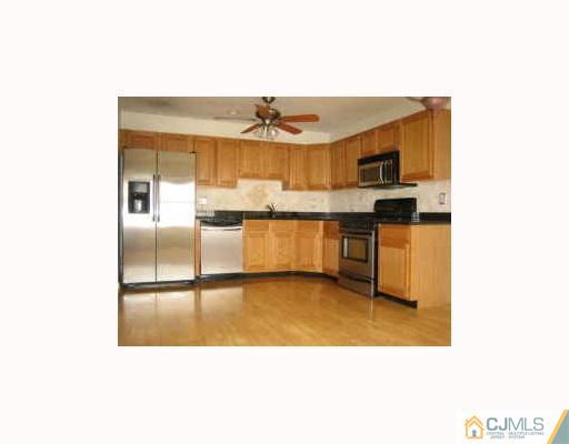 32 Inverness Drive Edison, NJ 08820 - Photo 4 of 9 a kitchen with stainless steel appliances a sink and cabinets