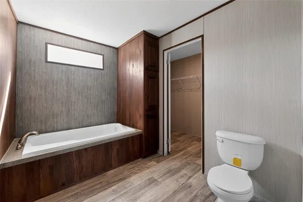a bathroom with a toilet a sink and bathtub