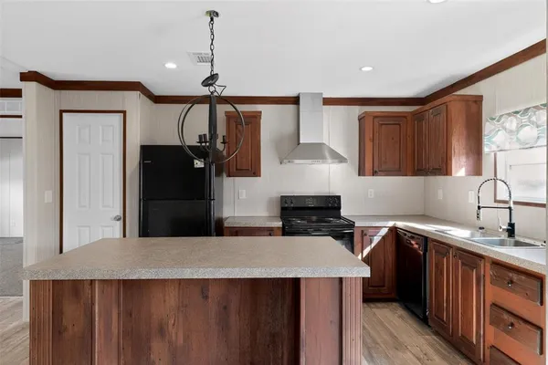 a kitchen with a sink a stove a refrigerator and cabinets