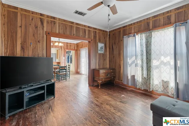 a view of livingroom with furniture hardwood floor and workspace