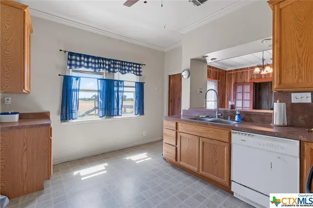 a kitchen with stainless steel appliances a sink stove and cabinets