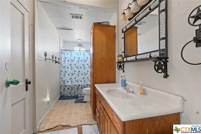 a bathroom with a sink and mirror
