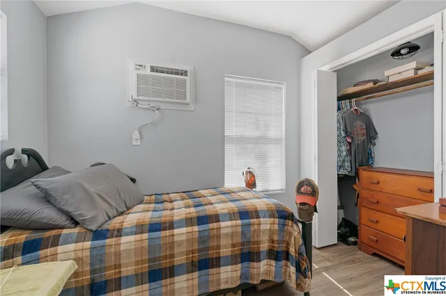 a bedroom with bed and a window