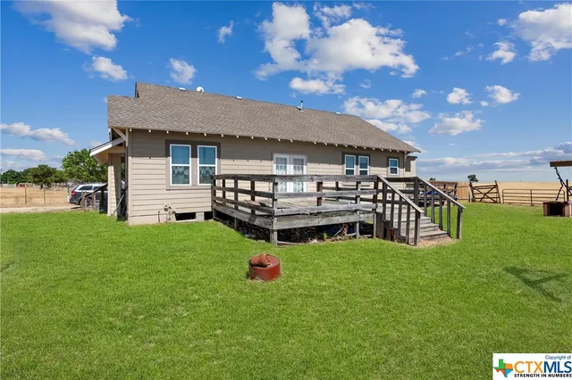 a view of a house with a backyard