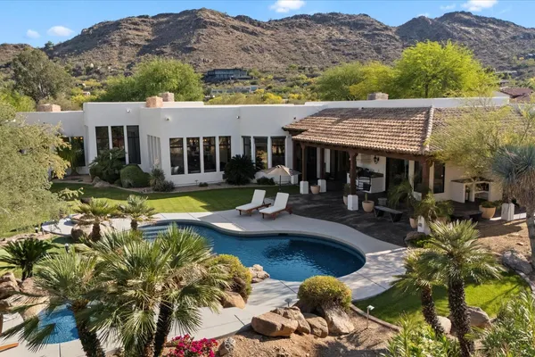 a view of a house with swimming pool and a yard