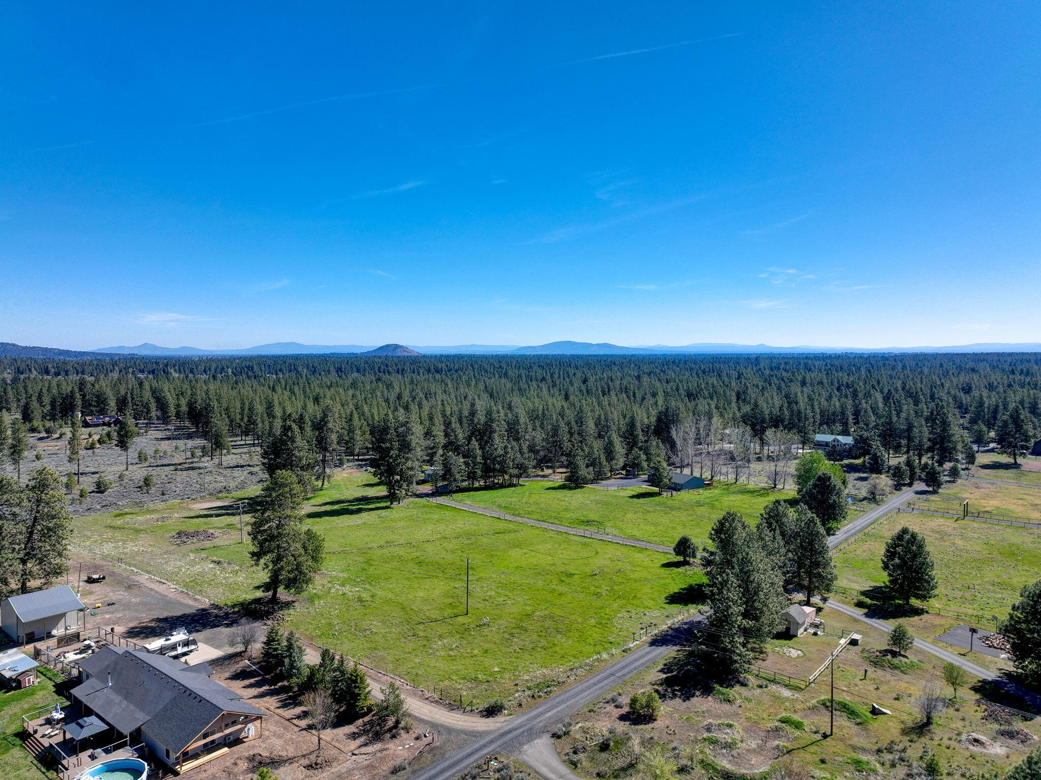 19450 Calico Road Bend, OR 97702 - Photo 26 of 41 a view of a lake with a yard