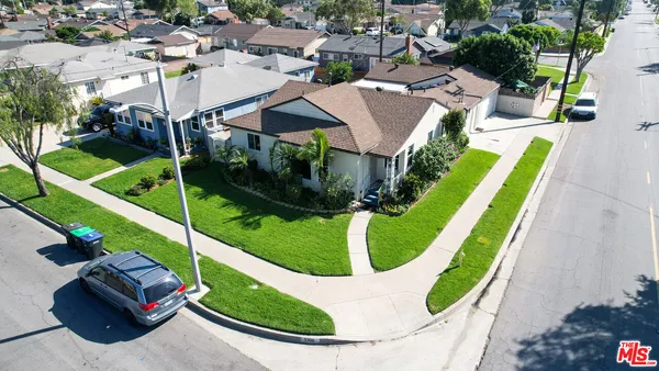 an aerial view of a house with a garden and swimming pool