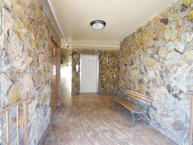 a view of small space with wooden floor and a rug