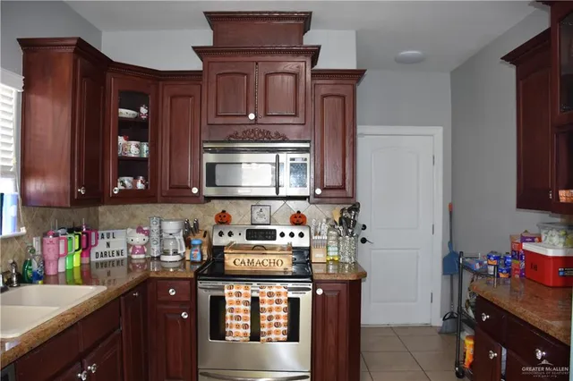 a kitchen with a sink cabinets and window