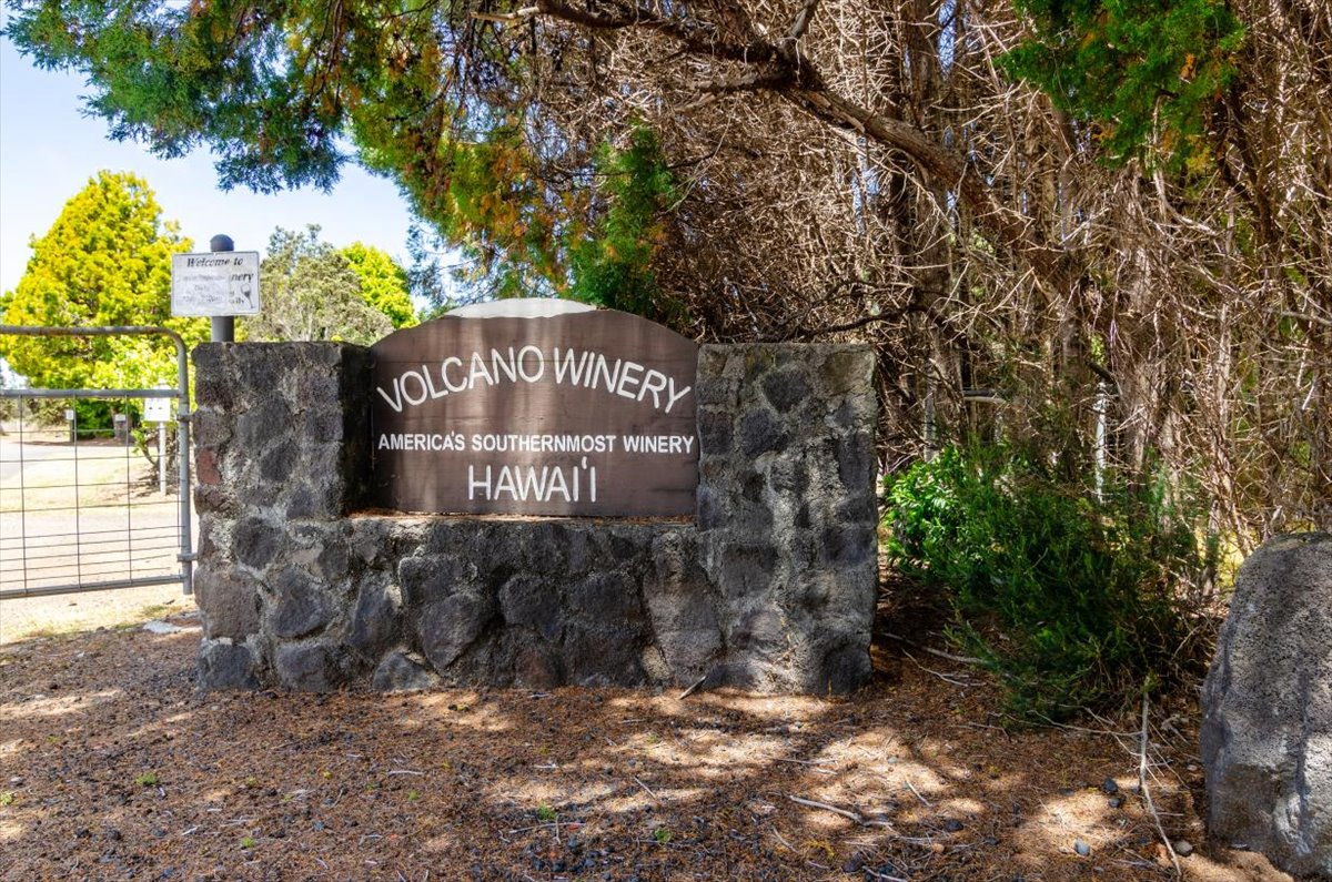 654 7th Street Volcano, HI 96785 - Photo 11 of 12 a sign that is sitting on a brick wall