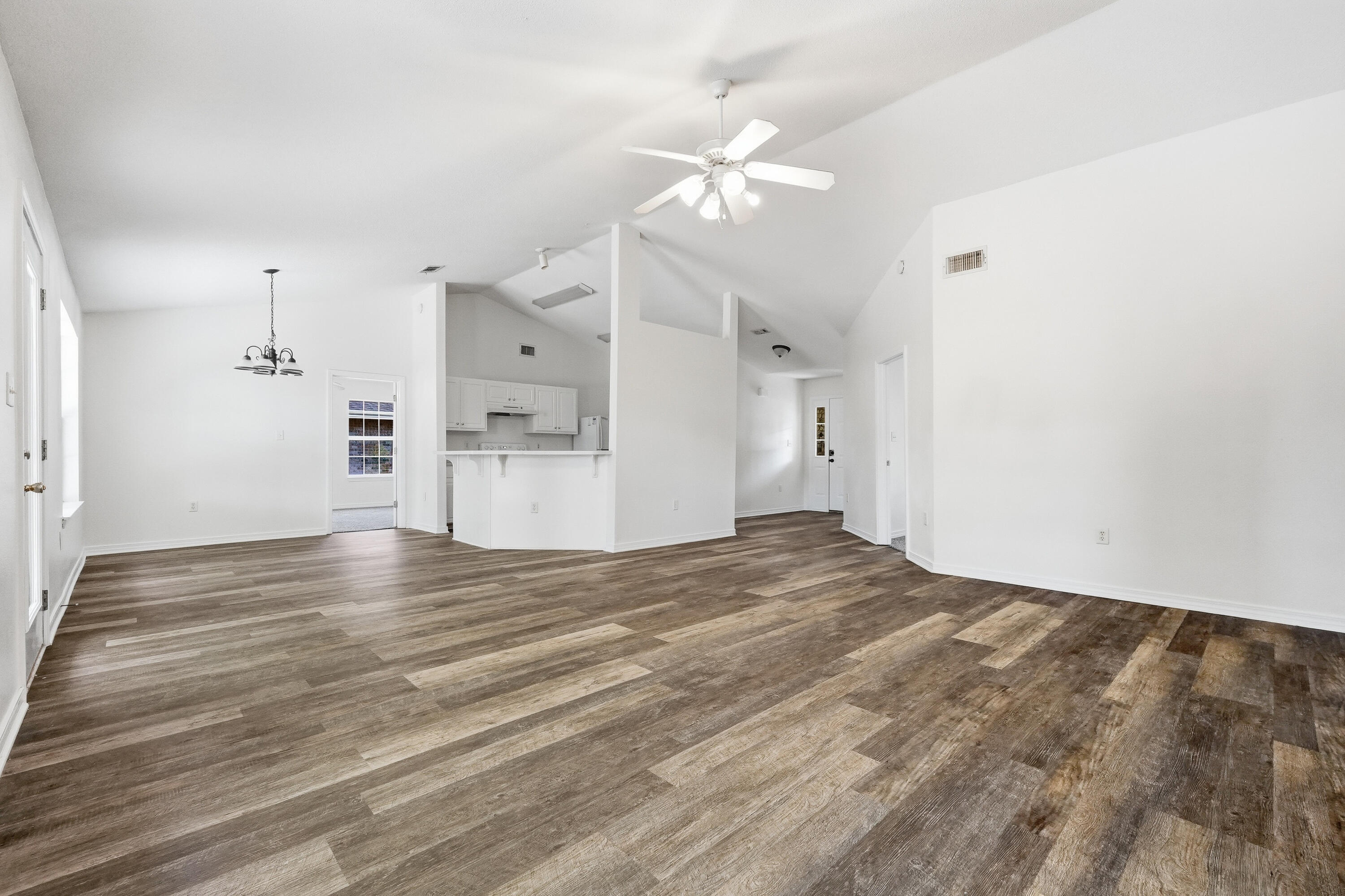 4087 Audiss Road Milton, FL 32583 - Photo 10 of 34 a view of empty room with wooden floor and window