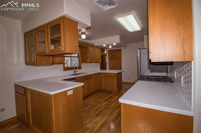 a kitchen that has a sink and a stove in it