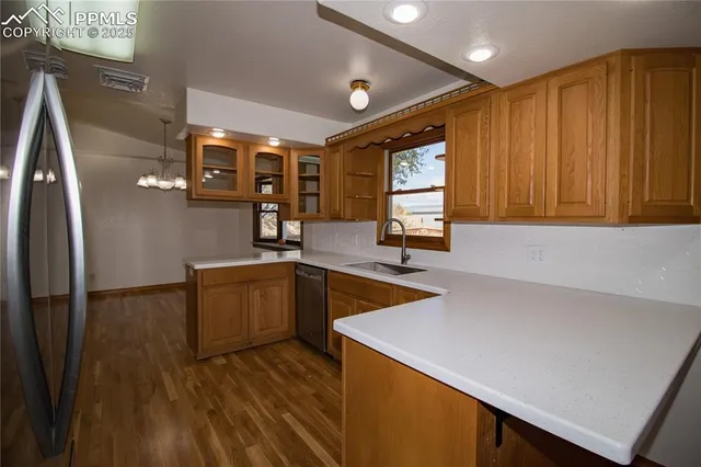 a kitchen with wooden cabinets and sink