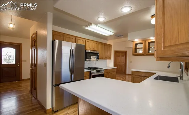 a kitchen with stainless steel appliances a refrigerator and a sink