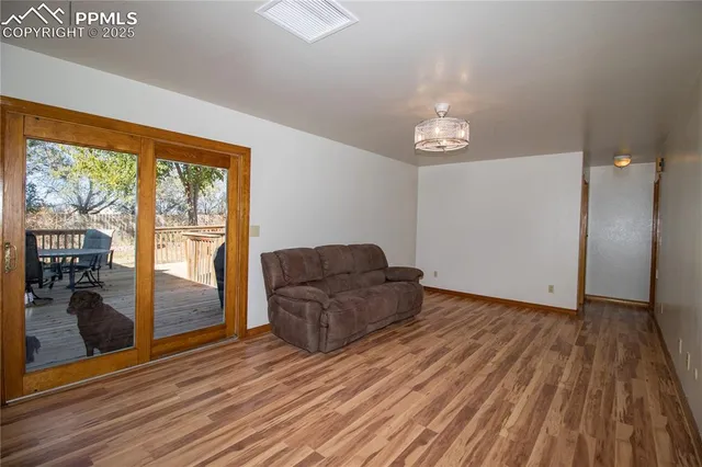 a living room with furniture and a floor to ceiling window