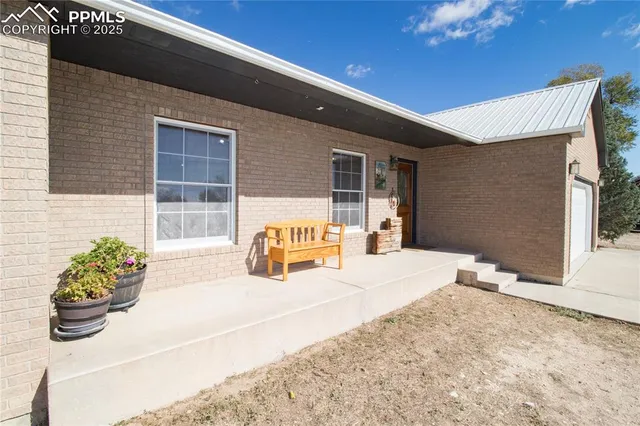 a spacious bedroom with a bed and a chandelier
