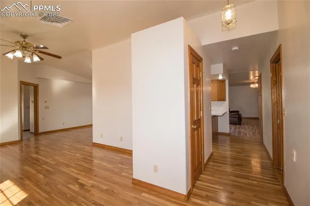 a view of a hallway with wooden floor