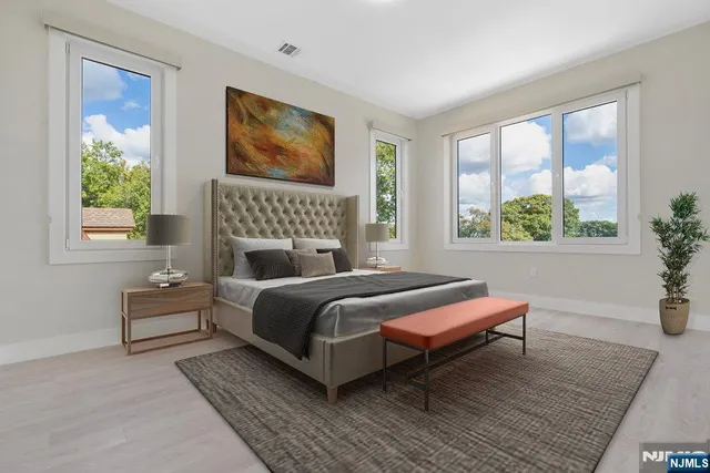 a bedroom with a bed wooden floor and window