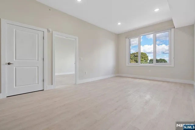 an empty room with windows and closet