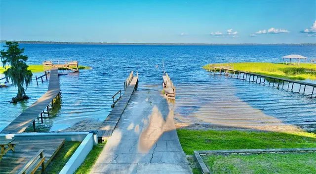 a view of a terrace with lawn chairs