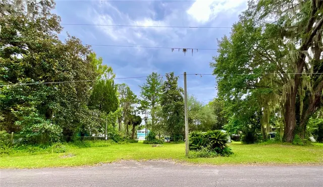 a view of a house with a backyard