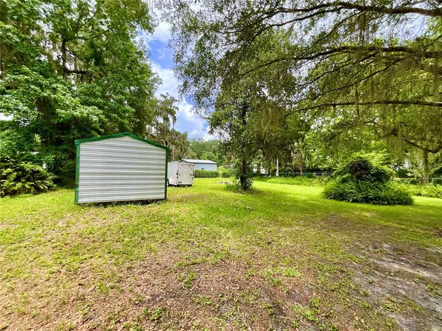 a backyard of a house with lots of green space