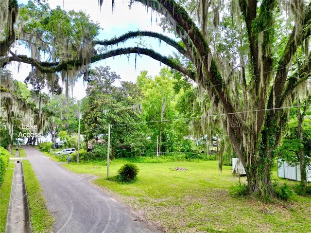 a backyard of a house with lots of green space and garden
