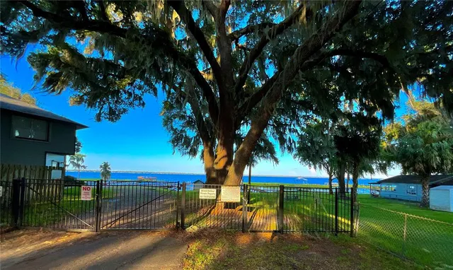 a view of swimming pool with table and chairs under an umbrella